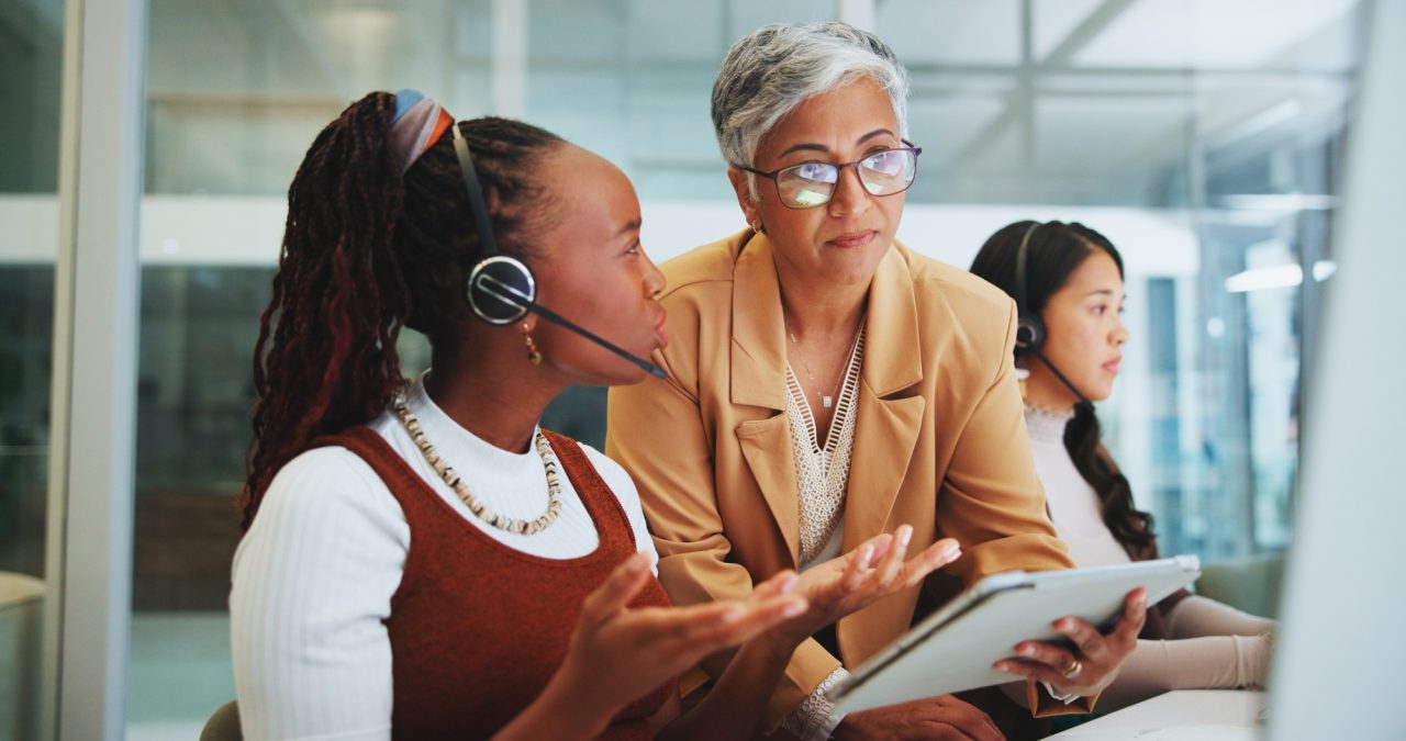 business-people-women-and-mentor-with-tablet-telemarketing-and-tech-support-in-modern-office